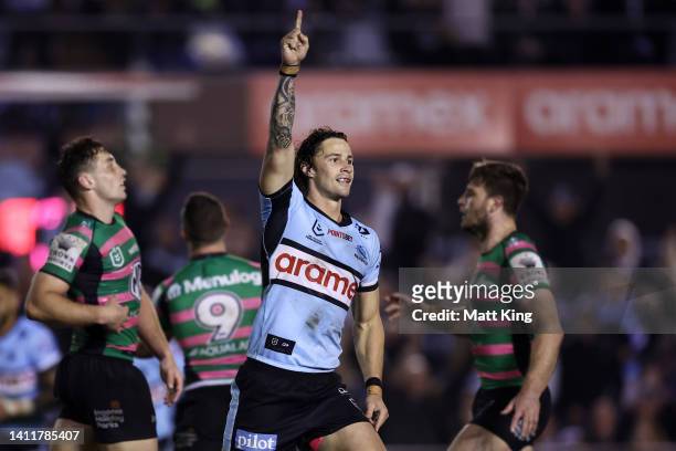 Nicho Hynes of the Sharks celebrates kicking a field goal to win the match in golden point extra time during the round 20 NRL match between the...