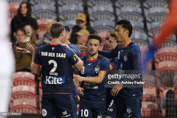 George Blackwood of Adelaide United celebrates his goal with team mates during the Australia Cup Rd of 32 match between the Newcastle Jets FC and...