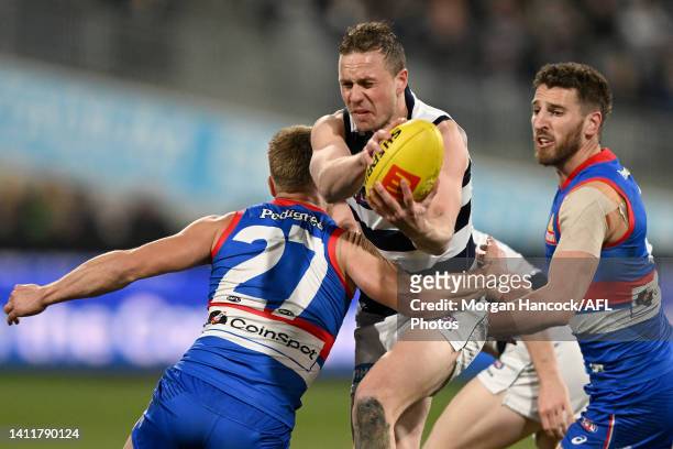 Mitch Duncan of the Cats handpasses the ball during the round 20 AFL match between the Geelong Cats and the Western Bulldogs at GMHBA Stadium on July...