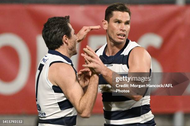 Isaac Smith and Tom Hawkins of the Cats celebrate a goal during the round 20 AFL match between the Geelong Cats and the Western Bulldogs at GMHBA...