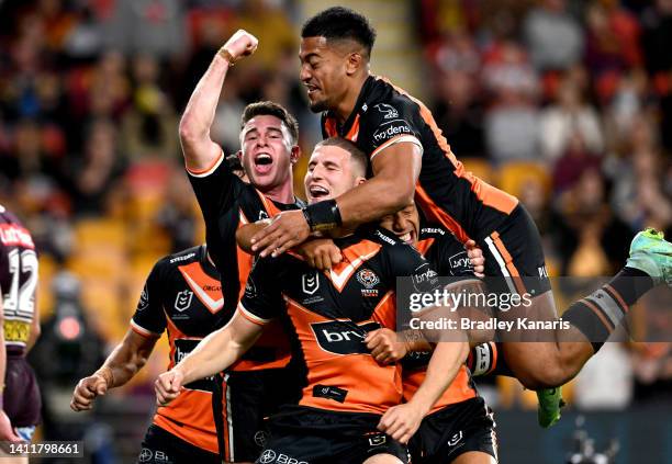Adam Doueihi of the Tigers celebrates scoring a try during the round 20 NRL match between the Brisbane Broncos and the Wests Tigers at Suncorp...