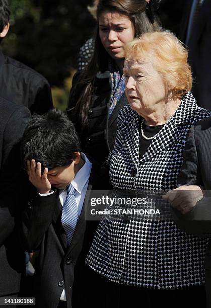 An unidentified family member wipes away tears next to Rosemarie Colvin , mother of slain Times of London correspondent Marie Colvin, after a funeral...