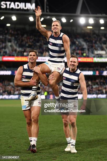 Joel Selwood of the Cats is chaired from the pitch following his 350th match in the round 20 AFL match between the Geelong Cats and the Western...