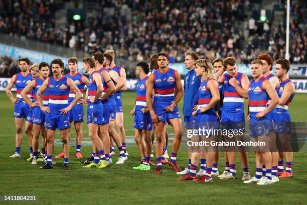 The Bulldogs look dejected following the round 20 AFL match between the Geelong Cats and the Western Bulldogs at GMHBA Stadium on July 30, 2022 in...