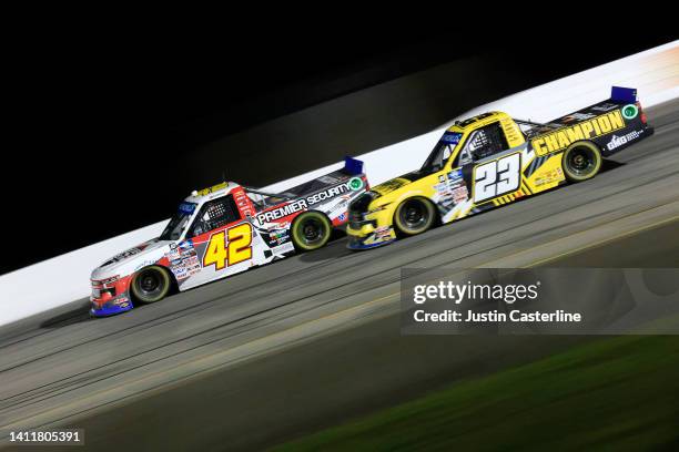 Carson Hocevar, driver of the Premier Security Solutions Chevrolet, and Grant Enfinger, driver of the Champion Power Equipment Chevrolet, race during...