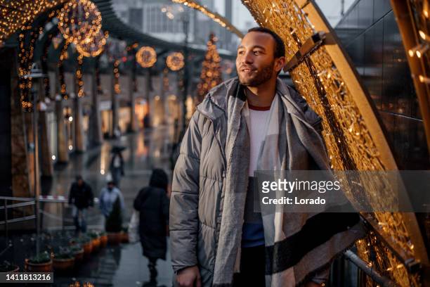 handsome man at christmas shopping - amsterdam christmas stock pictures, royalty-free photos & images