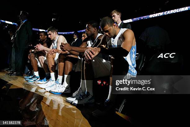 Harrison Barnes, Tyler Zeller, James Michael McAdoo, Reggie Bullock and Kendall Marshall of the North Carolina Tar Heels sit on the bench during...