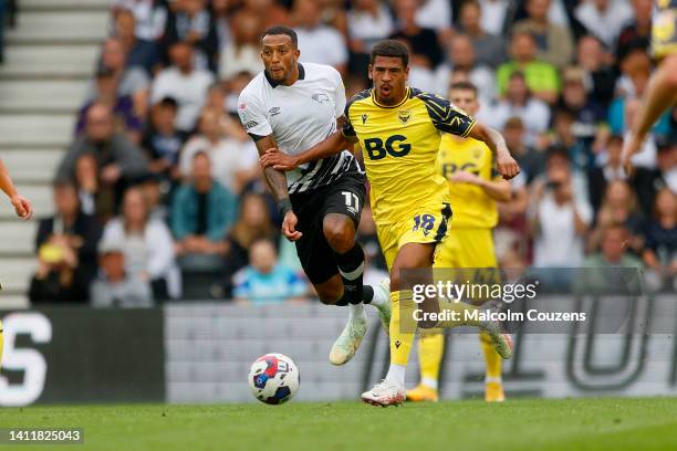 Nathaniel Mendez-Laing of Derby County competes with Marcus McGuane of Oxford United during the Sky Bet League One game between Derby County and...