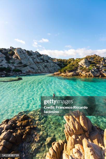 woman taking a bath at cala napoletana, beautiful bay in caprera, la maddalena archipelago, sardinia, italy - sardinien stock-fotos und bilder