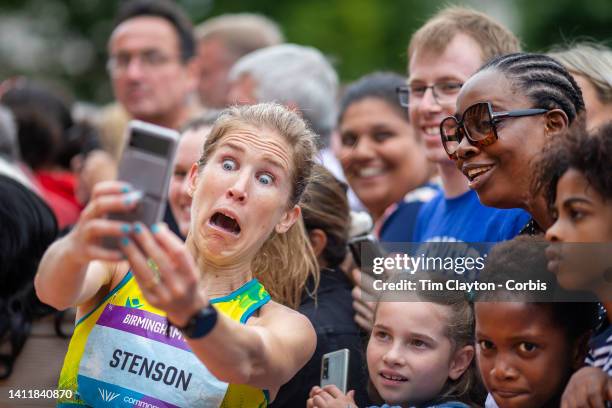 Jessica Stenson of Australia reacts as she takes selfies with spectators after winning the gold medal during the Women's Marathon at the Birmingham...