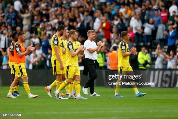 Oxford United manager Karl Robinson applauds the travelling supporter during the Sky Bet League One game between Derby County and Oxford United at...