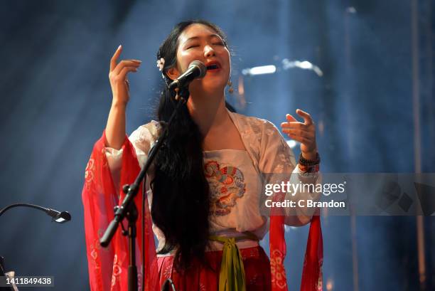 Cheng Yu & Silk Breeze perform on stage during the 40th Anniversary of the Womad Festival at Charlton Park on July 30, 2022 in Malmesbury, England.