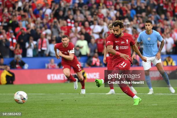 Mohamed Salah of Liverpool scores their side's second goal from a penalty, following a VAR Review confirms a handball by Ruben Dias of Manchester...