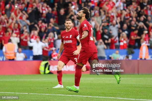 Mohamed Salah of Liverpool celebrates scoring their side's second goal from a penalty, following a VAR Review confirms a handball by Ruben Dias of...