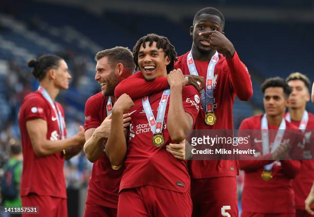 James Milner, Trent Alexander-Arnold and Ibrahima Konate of Liverpool celebrate after the final whistle of The FA Community Shield between Manchester...