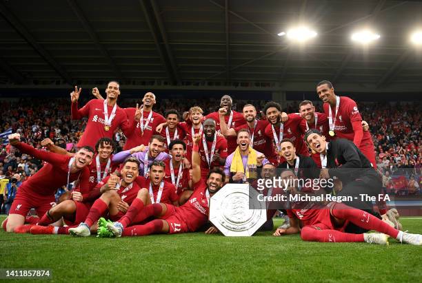 Players of Liverpool pose for a photograph with The FA Community Shield after the final whistle of The FA Community Shield between Manchester City...