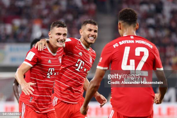 Benjamin Pavard of Bayern Munich celebrates scoring their side's third goal with teammates Lucas Hernandez and Jamal Musiala during the Supercup 2022...