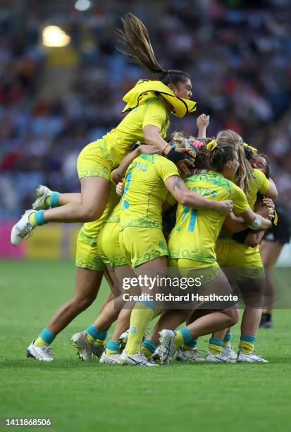 Team Australia celebrate after victory in the Women's Rugby Sevens Semi-Final match between Team Australia and Team New Zealand on day two of the...