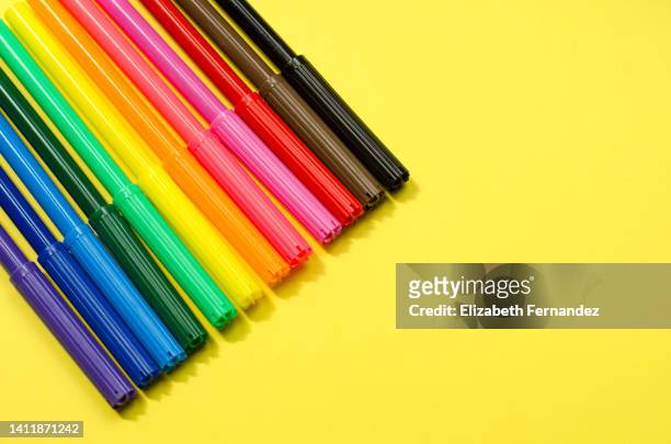 felt-tip pens in different colors on yellow background. back to school concept. - felt tip pen stock-fotos und bilder