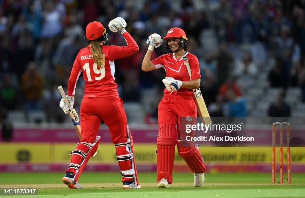 Maia Bouchier and Sophie Ecclestone of Team England celebrate victory during the Cricket T20 Preliminary Round Group B match between Team England and...