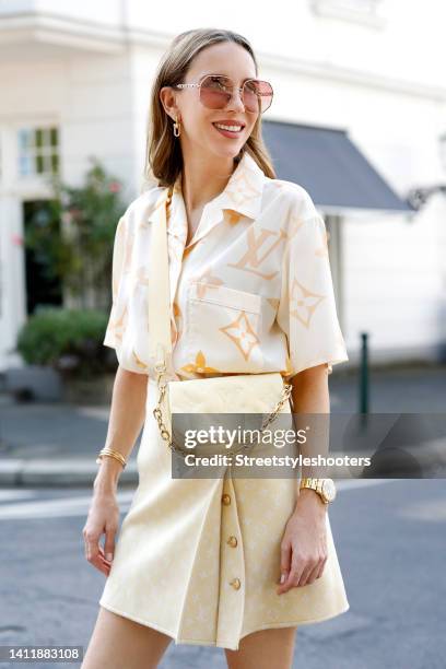 Alexandra Lapp wearing a pastel yellow shirt by Louis Vuitton, a pastel yellow mini skirt by Louis Vuitton, a pastel yellow bag by Louis Vuitton and...