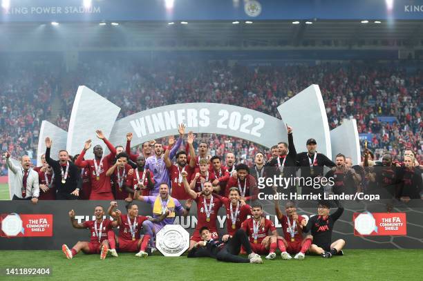 Liverpool players and staff celebrate with the FA Community Shield followign their team's victory in the FA Community Shield between Manchester City...