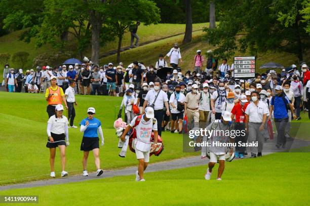 Mone Inami and Minami Katsu of Japan are followed by gallery on the 2nd hole during the final round of Rakuten Super Ladies at Tokyu Grand Oak Golf...