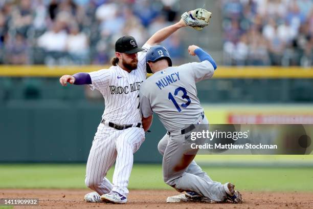 Max Muncy of the Los Angeles Dodgers steals second base against Brendan Rodgers of the Colorado Rockies in the second inning at Coors Field on July...