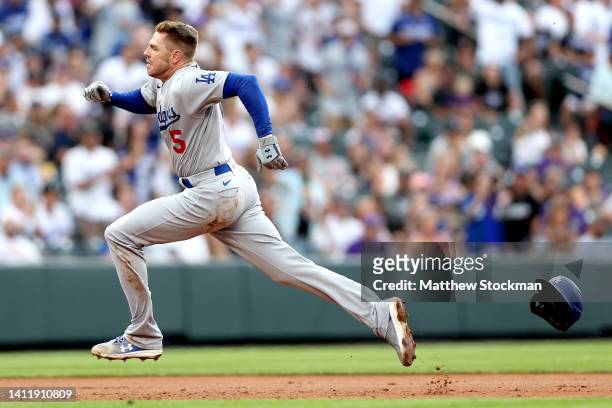 Freddie Freeman of the Los Angeles Dodgers runs to third base o a fielding error after hitting double against the Colorado Rockies in the third...