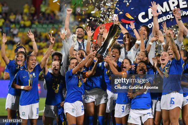 Tamires of Brazil, Rafaelle of Brazil and Debinha of Brazil lift the trophy with teammates after winning the final match between Brazil and Colombia...