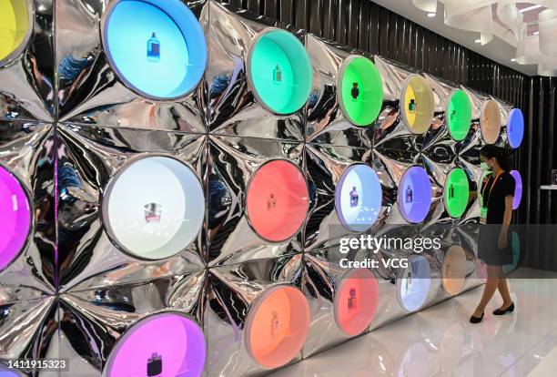 Bottles of perfume are on display at the booth of China Duty Free Group during the 2nd China International Consumer Products Expo at the Hainan...