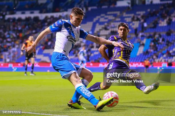 Israel Reyes of Puebla fights for the ball with Javier Guemez of Atletico San Luis during the 6th round match between Puebla and Atletico San Luis as...