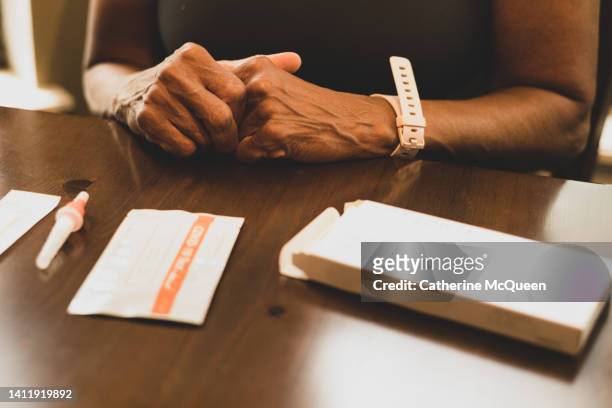 black woman prepares to take at-home covid-19 test - preventive care stock pictures, royalty-free photos & images