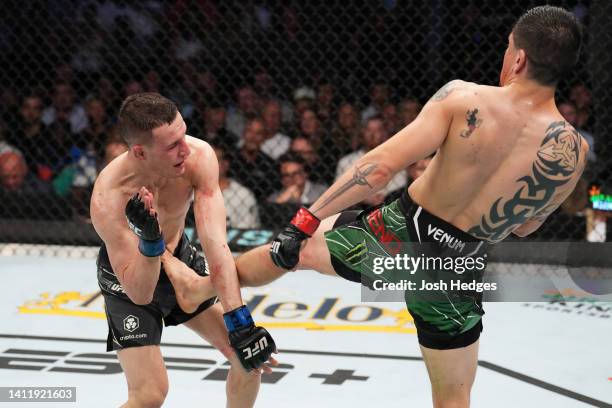 Brandon Moreno of Mexico lands a kick to the body of Kai Kara-France of New Zealand in the interim UFC flyweight championship fight during the UFC...