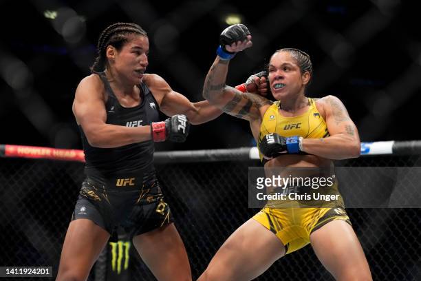 Julianna Pena punches Amanda Nunes of Brazil in the UFC bantamweight championship fight during the UFC 277 event at American Airlines Center on July...