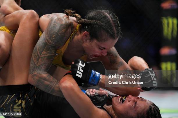 Amanda Nunes of Brazil elbows Julianna Pena in the UFC bantamweight championship fight during the UFC 277 event at American Airlines Center on July...