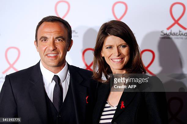 French TV hosts Nikos Aliagas and Magali Lunel pose on March 12, 2012 as they arrive at the Quai Branly Musuem in Paris, to attend the 18th edition...