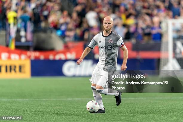 Michael Bradley of Toronto FC dribbles during a game between Toronto FC and New England Revolution at Gillette Stadium on July 30, 2022 in...