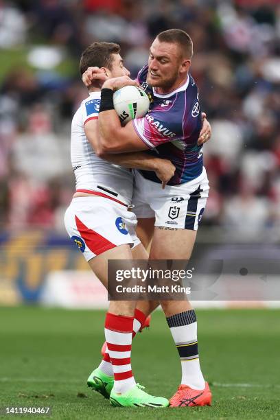 Coen Hess of the Cowboys is tackled by Andrew McCullough of the Dragons during the round 20 NRL match between the St George Illawarra Dragons and the...