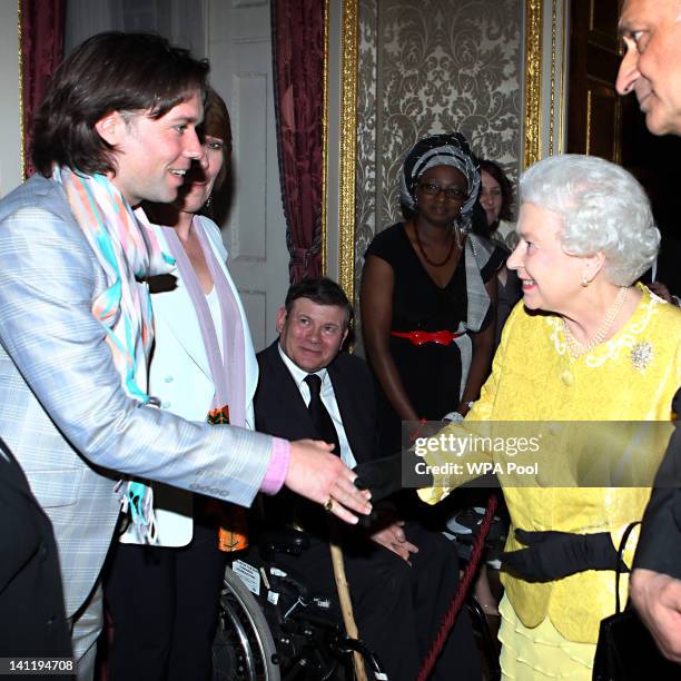 Queen Elizabeth II shakes hands with Rufus Wainwright during a Commonwealth Day Reception at Marlborough House on March 12, 2012 in London, England.