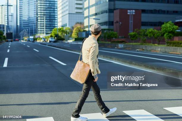 asian businessman crosses an urban pedestrian crossing - shinjuku ward bildbanksfoton och bilder