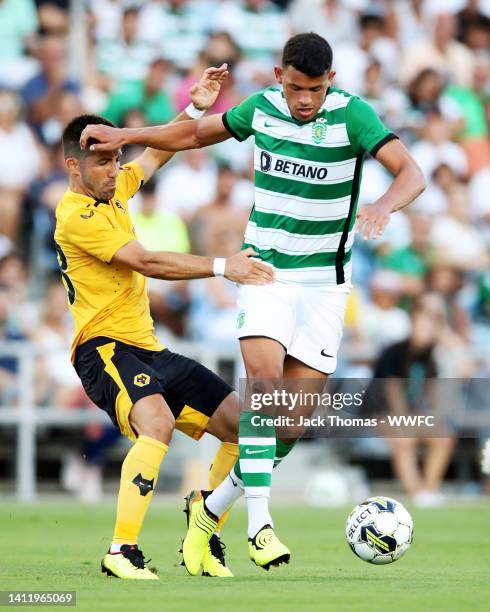 Matheus Nunes of Sporting CP is challenged by Joao Moutinho of Wolverhampton Wanderers during the Pre-Season Friendly between Wolverhampton Wanderers...