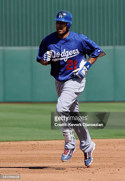 Juan Rivera of the Los Angeles Dodgers circles the bases after a solo home run in the second inning of a spring training baseball game against Los...