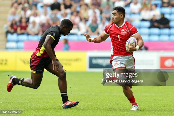 Sione Tupou of Team Tonga runs with the ball during the Men's 9-12 Semi-Final match between Team Uganda and Team Tonga on day three of the Birmingham...