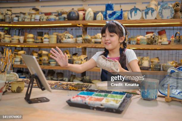 little influencer making social media video about pottery product. - very young webcam girls stockfoto's en -beelden