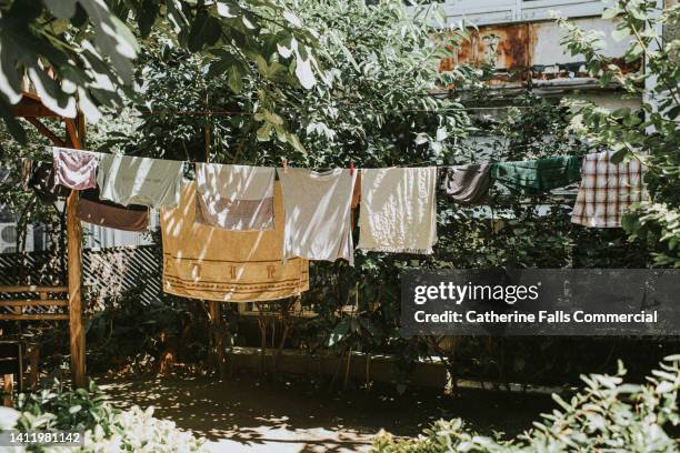 damp clothing hanging on a washing line - 乾かす ストックフォトと画像