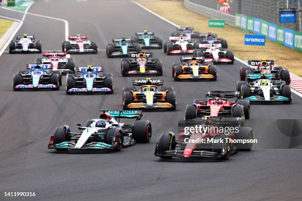 George Russell of Great Britain driving the Mercedes AMG Petronas F1 Team W13 and Carlos Sainz of Spain driving the Ferrari F1-75 battle for track...