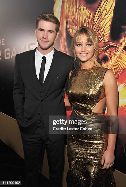 Actors Liam Hemsworth and Jennifer Lawrence arrive at "The Hunger Games" Los Angeles premiere held at Nokia Theatre L.A. Live on March 12, 2012 in...