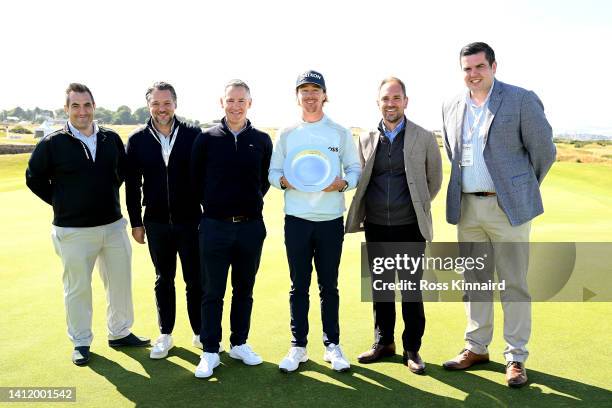 Sean Crocker of United States attends the trophy ceremony while poses with the Chief Owners Representative of Great Century after winning the Hero...