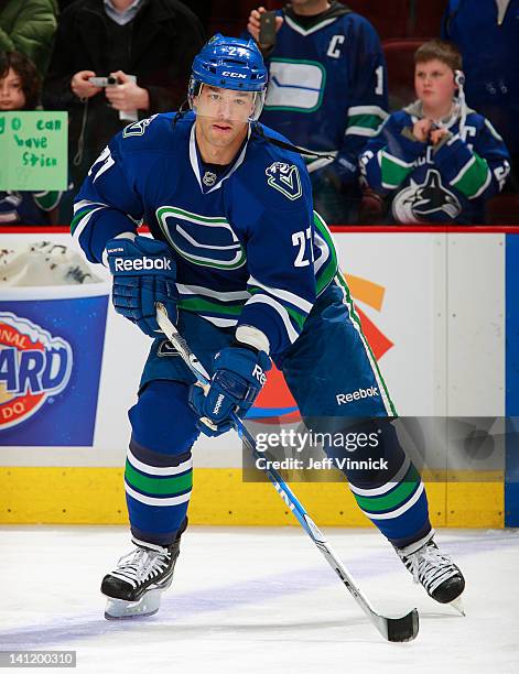 Manny Malhotra of the Vancouver Canucks skates up ice with the puck during a NHL game against the Vancouver Canucks at Rogers Arena March 10, 2012 in...